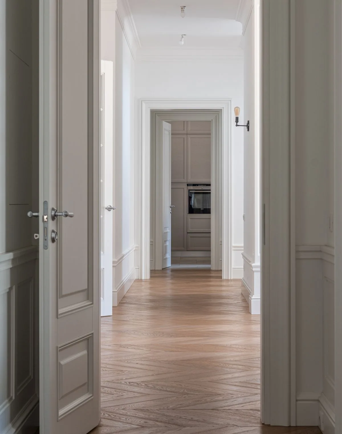 Painted gray paneled doors and casings catching daylight